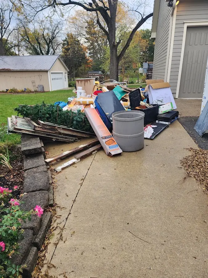 Dumpster being loaded with debris for Demolition Dumpster Rental in North Fork